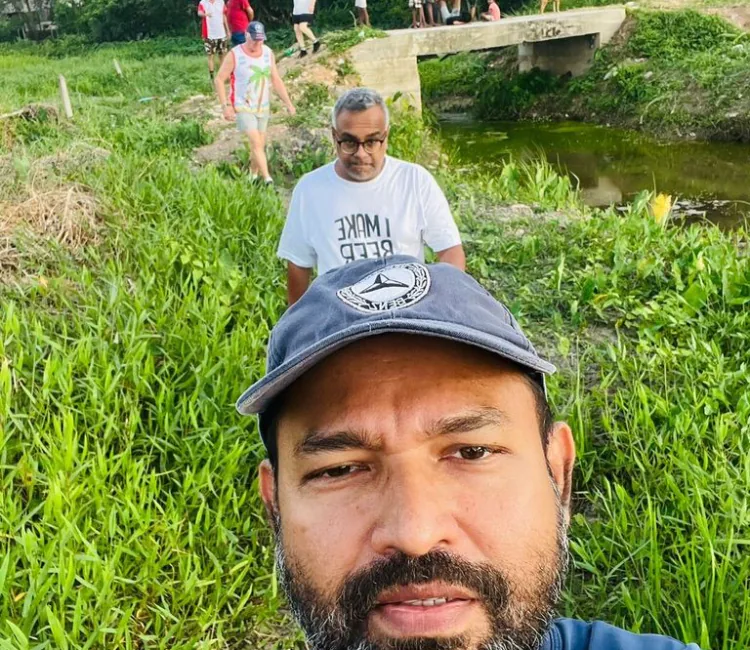 CH3 hashers following a trail beside a small bridge and waterway