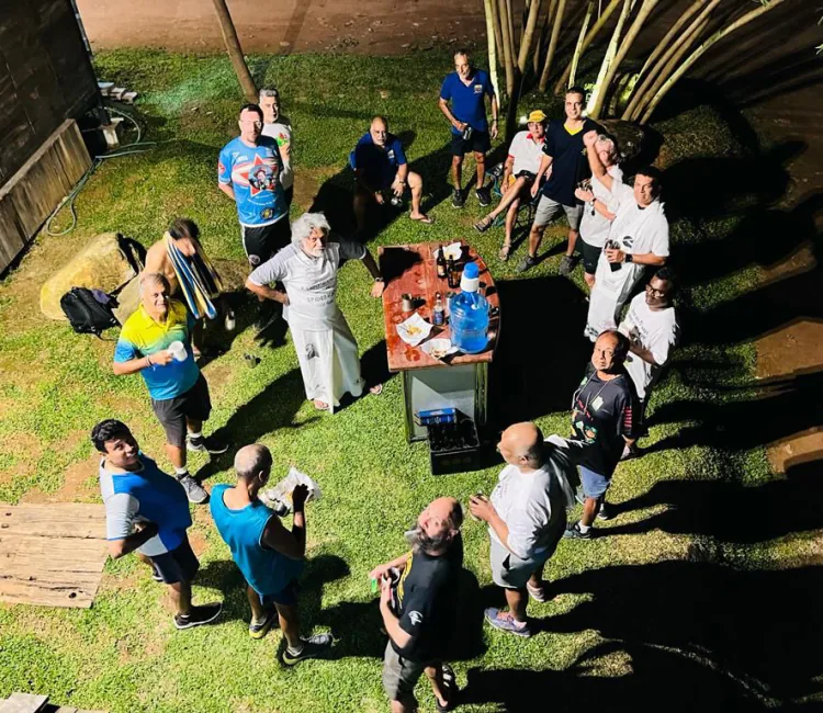 CH3 members gathered in a circle around a table after a run